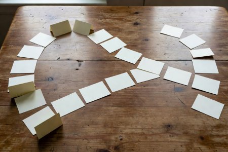 Spread of index cards splitting into two distinct chapter sequences on a wooden table